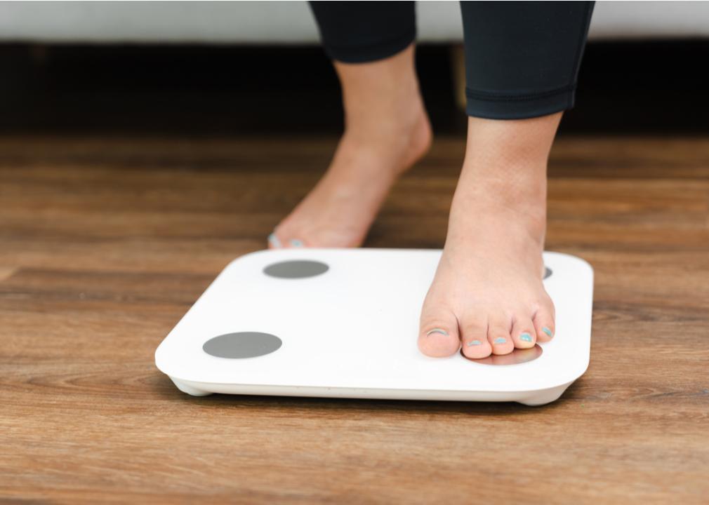 A person stepping onto a scale.
