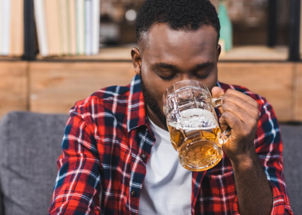 A man sitting alone drinking.