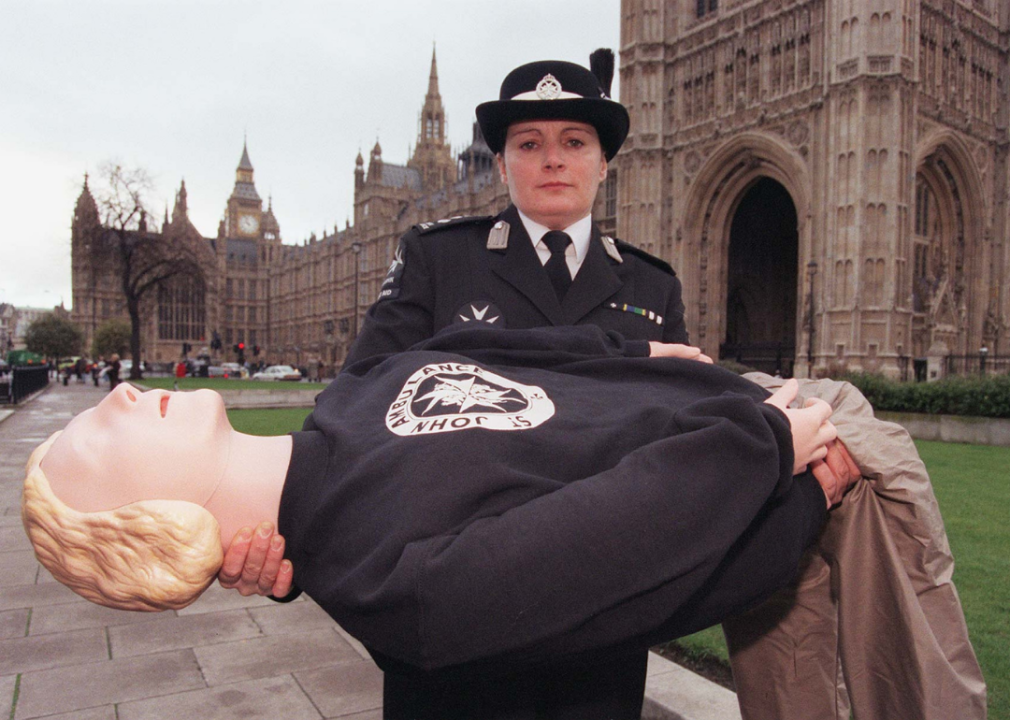 Linda Dominguez, manager of the St John Ambulance First Aid Services, holding a 'Resusci Annie' mannequin